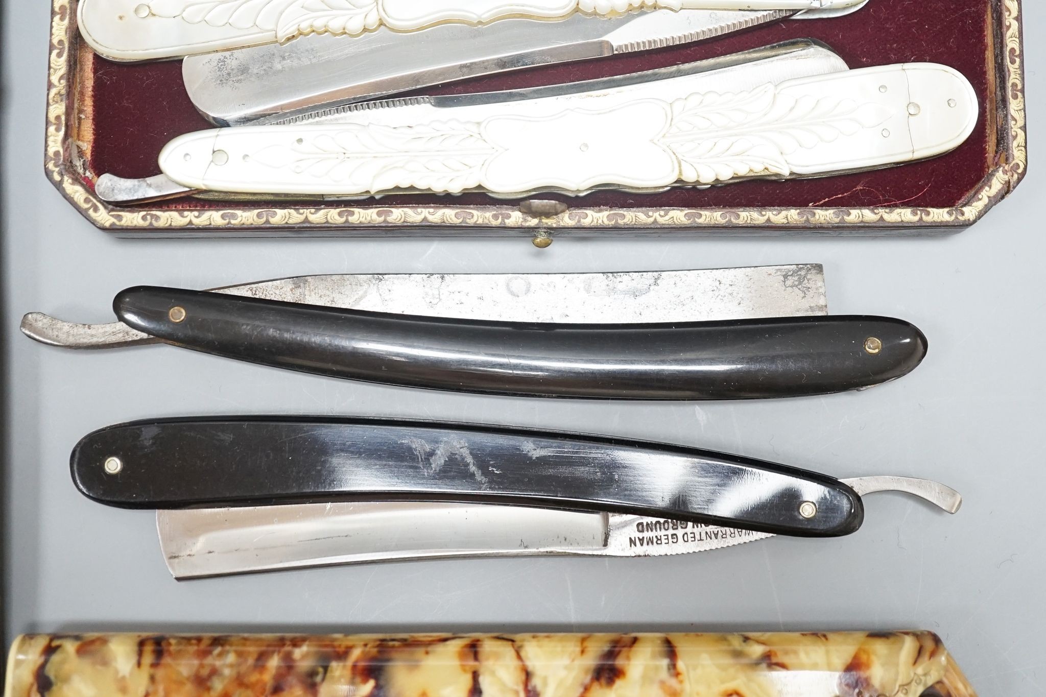 A leather cased pair of mother-of-pearl handled cut throat razors, by J Crawford and three other cased cut throat razors (4)